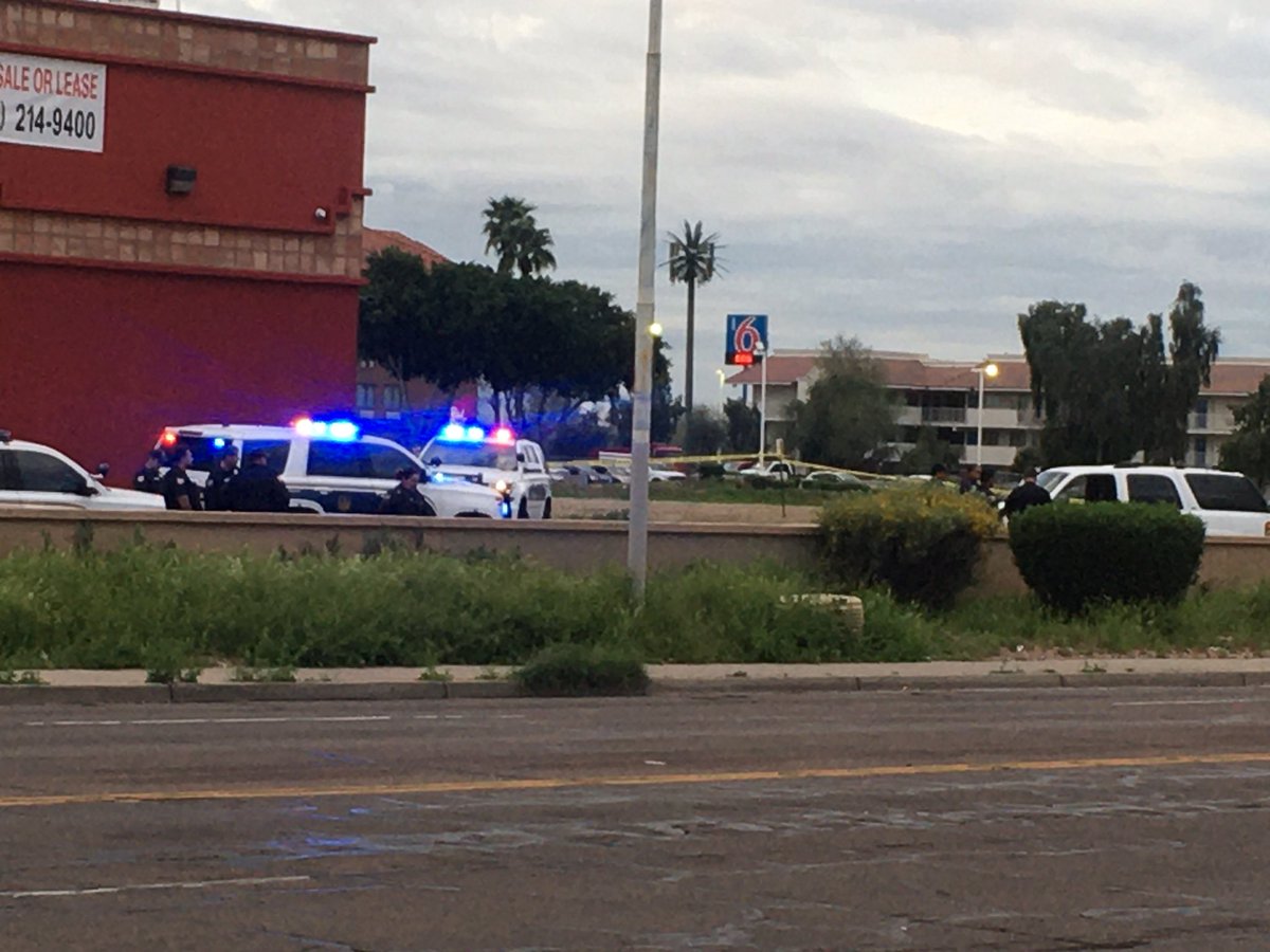 51st Ave at Indian School blocked for a shooting investigation. Focus is on a white SUV.