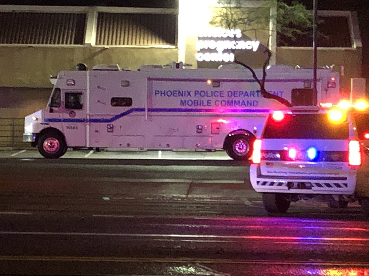 Several bullet holes in driver's side window. Phoenix PD mobile command just showed up. This is at 19th Ave and Camelback. Intersection shut down all directions. Shooting investigation is impacting light rail and bus routes