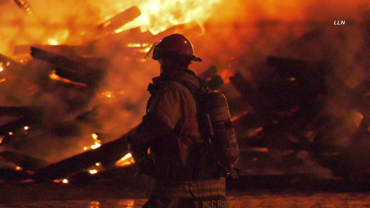 The fire is now heavily knocked down here at the 2nd alarm railroad tie fire. Crews are continuing to work on hot spots. I-10 has been re-opened in both directions