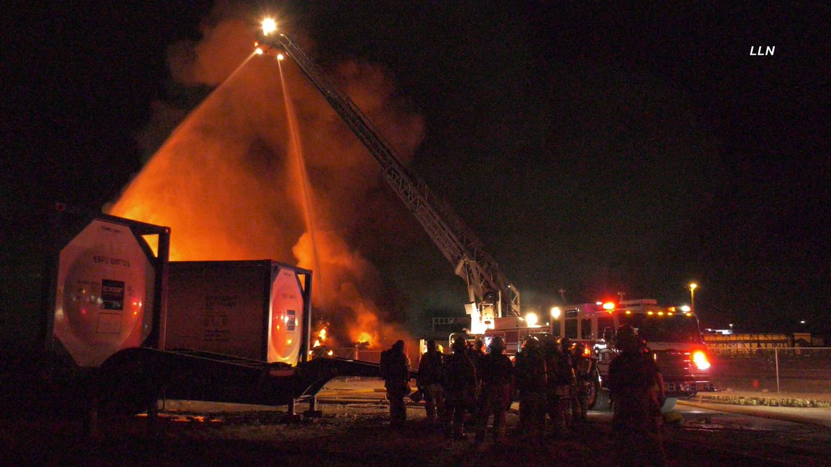 The fire is now heavily knocked down here at the 2nd alarm railroad tie fire. Crews are continuing to work on hot spots. I-10 has been re-opened in both directions