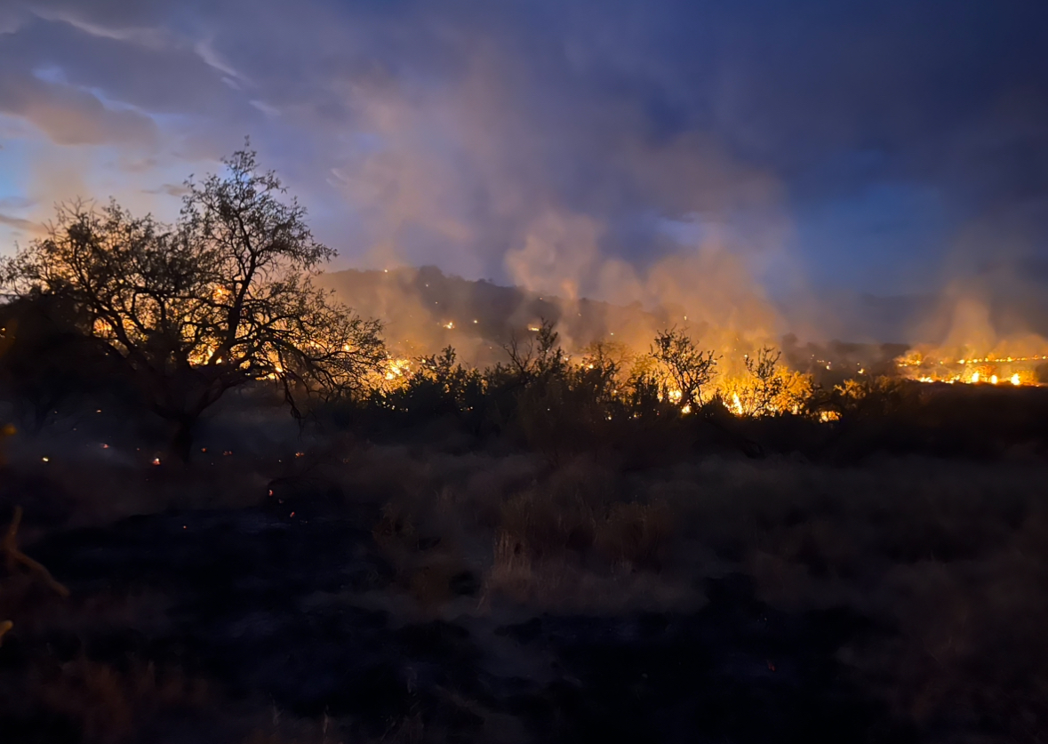 FloodFire : Fire made significant push overnight to NW due to outflow winds that hit fire area. Gusts up to 30mph fanned fire in all directions - creating erratic fire behavior. Fire activity has moderated some this am, but fire still active & making push uphill. Est. 